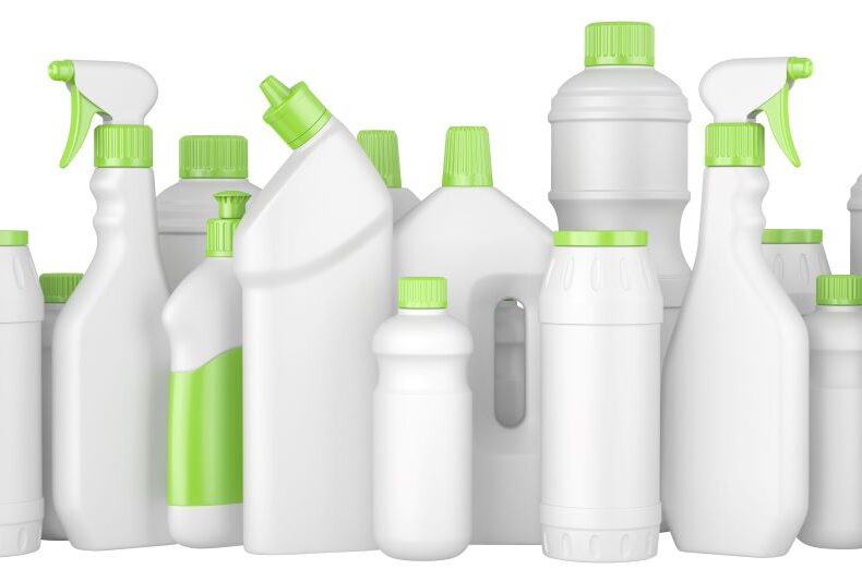 Plastic-detergent-bottles-with-green-caps-in-a-row.-593318544_8500x3128