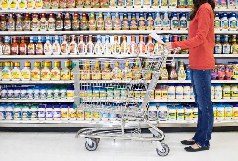 Shopper-checking-list-in-supermarket-aisle-517974032_5130x3420